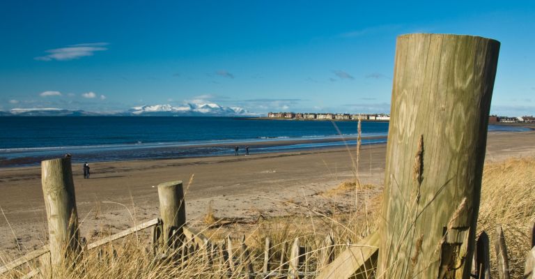 Snow capped mountains of Arran in the distance from Troon beach, South Ayrshire, Scotland