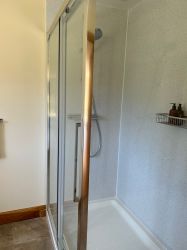 Shower cubicle in downstairs shower room with power shower, slight step into the cubicle