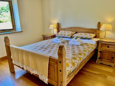 Downstairs bedroom has a king size bed