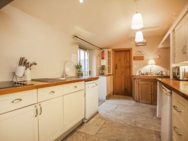 Galley Kitchen well stocked with plenty of cooking equipment and crockery