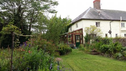 Rear view of cottage with part of garden