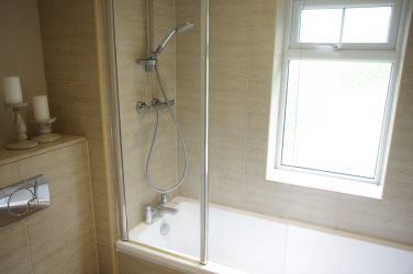 Modern bathroom with bath and power shower