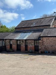 The main entrance to the cottage, with glazed entrance hall opening onto the living room and kitchen