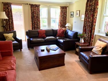 Spacious, comfortable lounge with woodburner