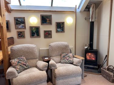 Two comfy recliners by the wood burner