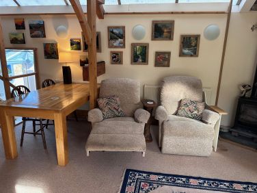 Two comfy recliners by the wood burner
