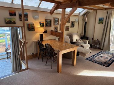 The dining area, and stairs down into the conservatory