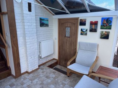 Conservatory with door leading to utility room