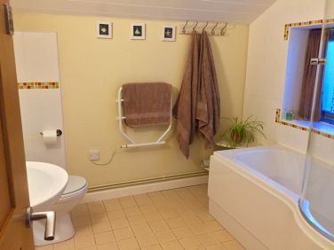 Main ensuite bathroom with shower over bath