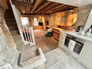 The open-plan layout of the living room and kitchen allows the cook to always have company