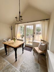 Sun room leading to downstairs cloakroom.