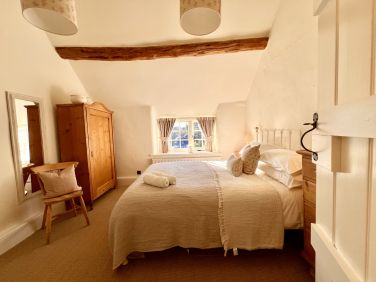 Bedroom with king-size bed that enjoys the morning sun