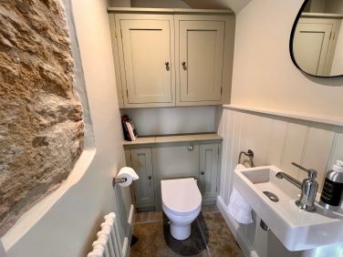 Additional ground floor cloakroom with WC, wash basin and cupboards housing the boiler