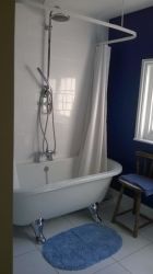 Bathroom with hand held and over bath shower