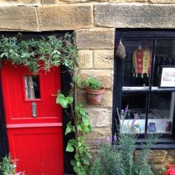 Passion flowers around the door at Staithes Holiday Cottage