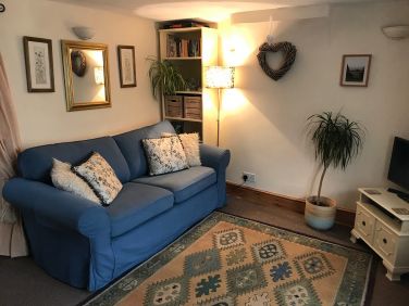 Sitting room book case with plenty of games, books and tourist maps and guides.