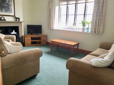 Light and airy lounge looking out over the gatden