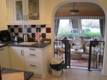 Fully equipped kitchen looking out into conservatory