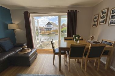 Lounge with doubles door to private decking