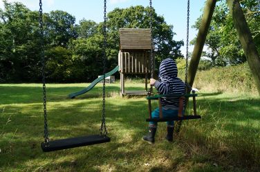 Swings and play fort in the old orchard at Hucklesbrook Farm