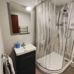 Bathroom - shower enclosure and vanity unit with basin