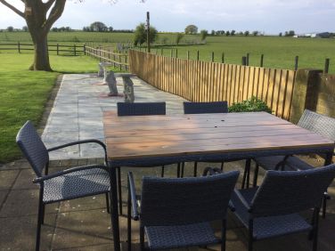 Patio with table and chairs for outside eating.