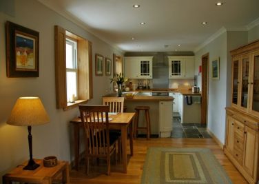 Dining area and kitchen. Microwave, air fryer, induction hob, double oven, dishwasher.