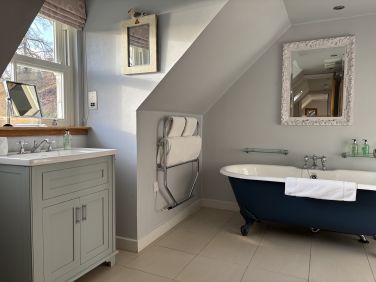 Roll top bath, walk in shower, sea view from bathroom window