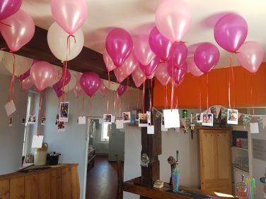 Photographs hanging from balloons - a great way to share your memories.
