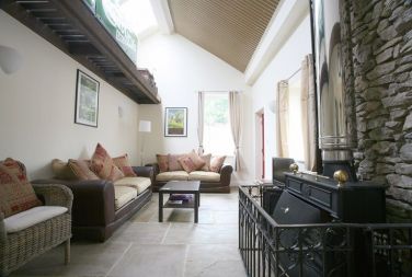 Spacious lounge with log burner