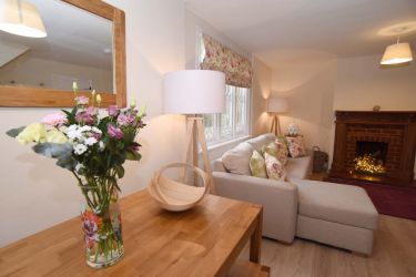 Welcoming sitting room with open fire