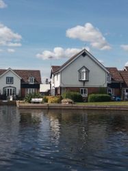 View of the holiday cottages from across the River Bure