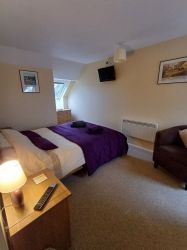 View from the landing of double bedroom with kingsize bed.