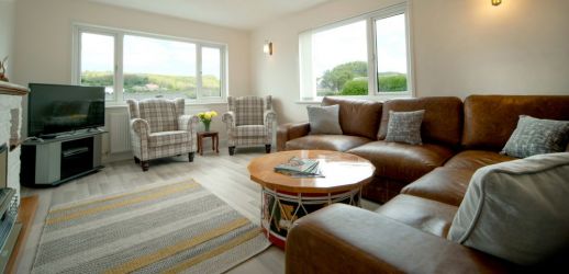 Main lounge with dual aspect, large comfy seating and smart TV.