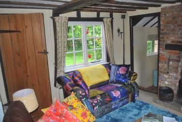 Our latest purchase: vibrant sofa - looks great with the garden roses behind!