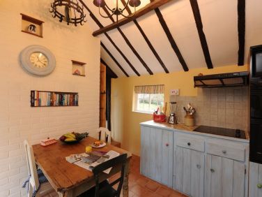 Kitchen leads (down steps) into Conservatory.  boatmansriversideholidaycottage.co.uk has floor plan