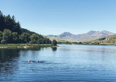Wild swimming in Llyn Mymbyr a two minute walk from the church.