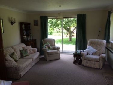 Cosy sitting room with access to patio and views of surrounding hills