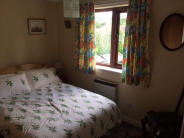 Bedroom 3 with built in wardrobe and views of rear garden and surrounding hills