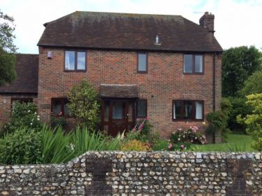 Traditional style house, flint boundary wall and much admired front garden