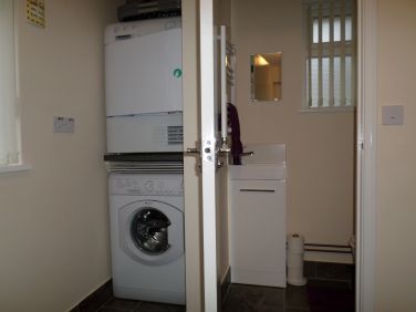 Utility area with separate toilet.