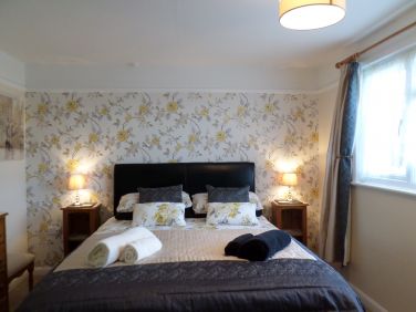 Master bedroom with king sized bed.