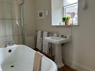 The ensuite bathroom to Tatiana bedroom with roll top bath and shower cubicle