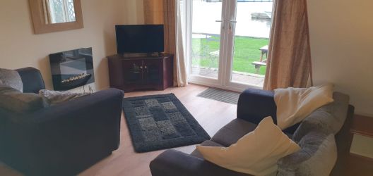 Living room with 2 comfy sofas and new wood floor.
