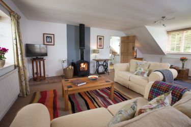 The lounge with comfy sofas, Smart TV and log burner