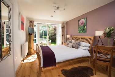 Ground floor double en suite bedroom with French doors leading to the private fully enclosed garden