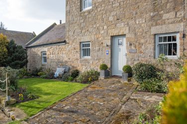 Pretty front flower garden with seating