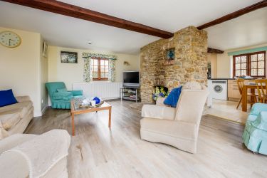 View from French windows showing lounge & kitchen