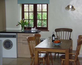 Far end of kitchen showing dining table