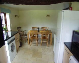 Kitchen view from sink and  washing machine dishwasher tumble dryer